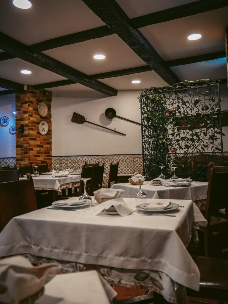 Adega Típica restaurant in Aveiro, set tables, warm and rustic atmosphere.