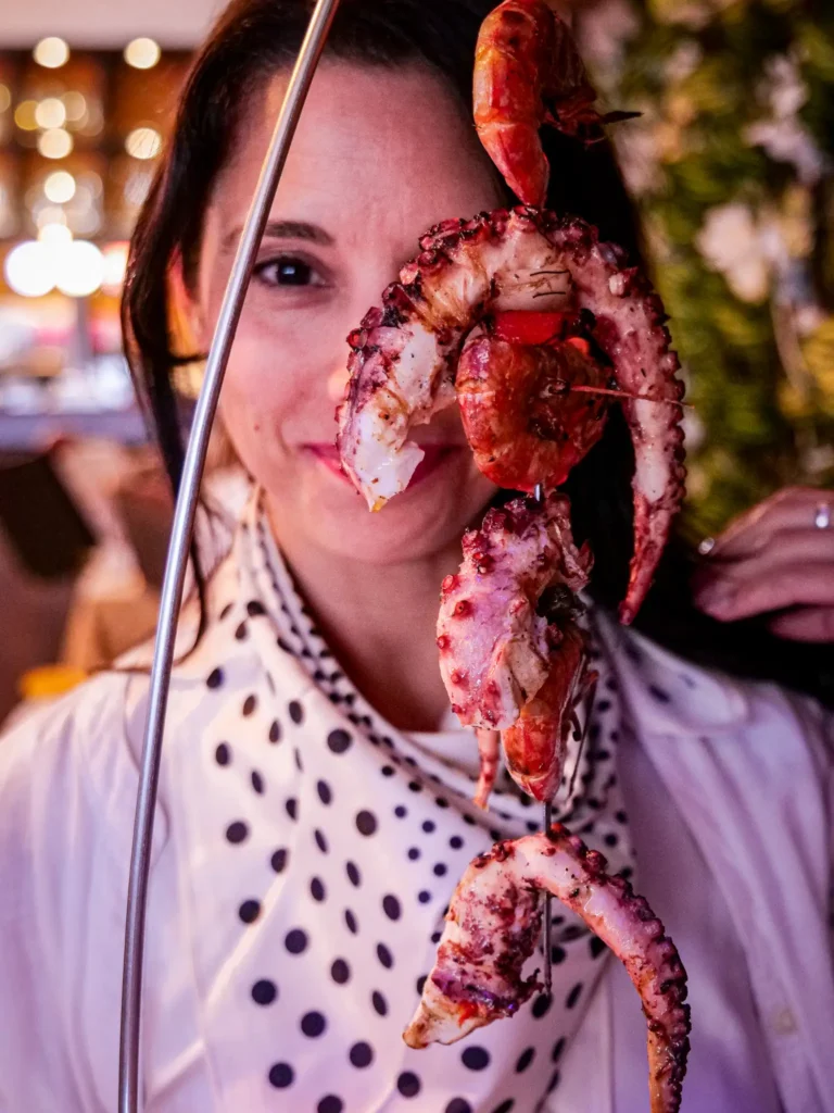 Caroline enjoying a seafood skewer at the restaurant Polvo e Companhia, Santa Luzia, Algarve.