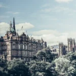 Panoramic view of Edinburgh's historic landmarks under a partly cloudy sky