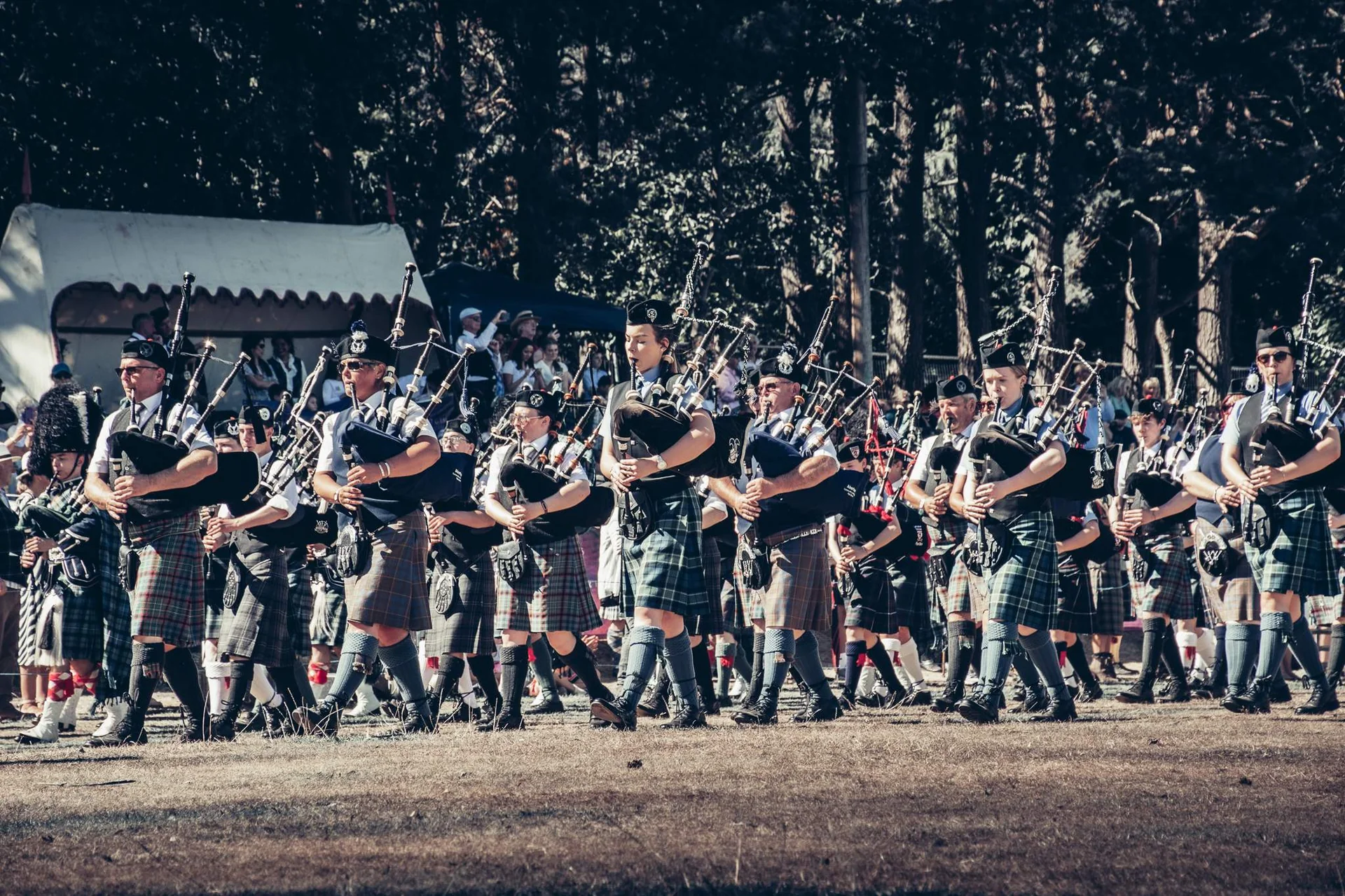 Pipe band parade in kilts at the Highland Games in Scotland