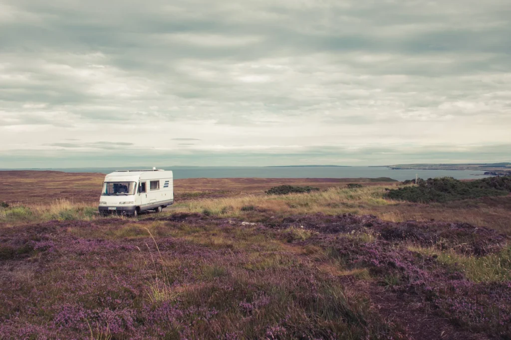 Isolated motorhome parked on a Scottish heath in the north with a sea view