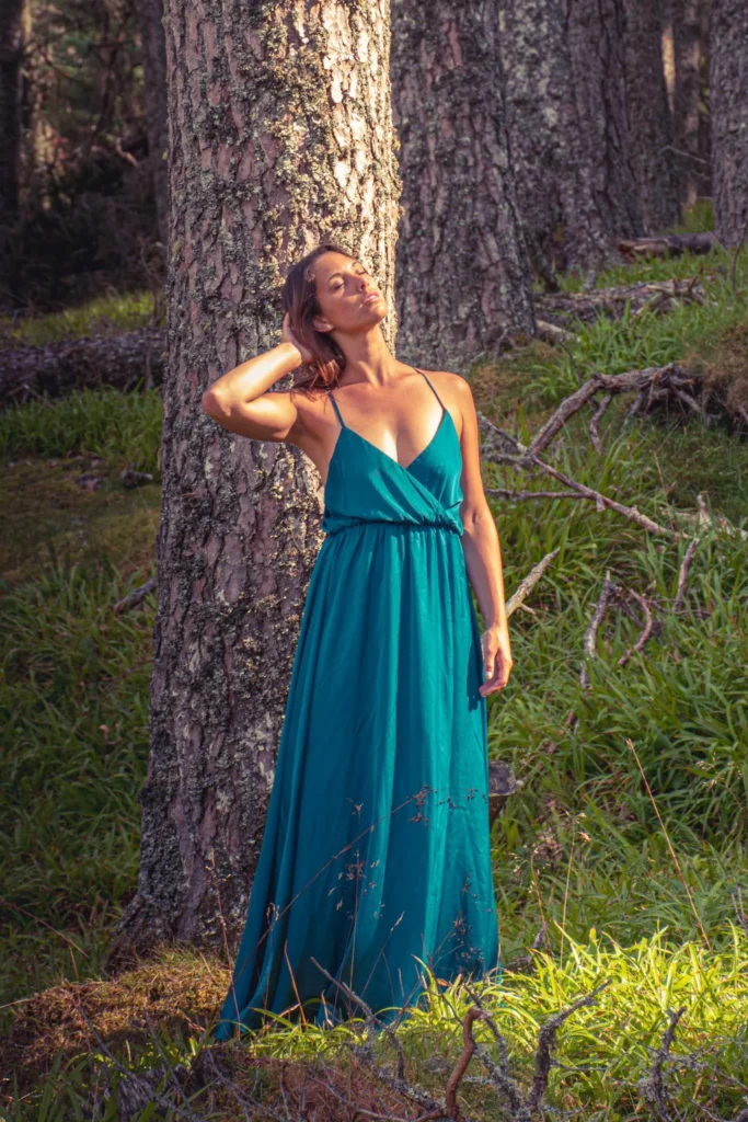 Caroline in a blue dress in a forest of Caledonian pines in the Cairngorms National Park