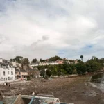 Colorful houses of Portree harbor at low tide Isle of Skye