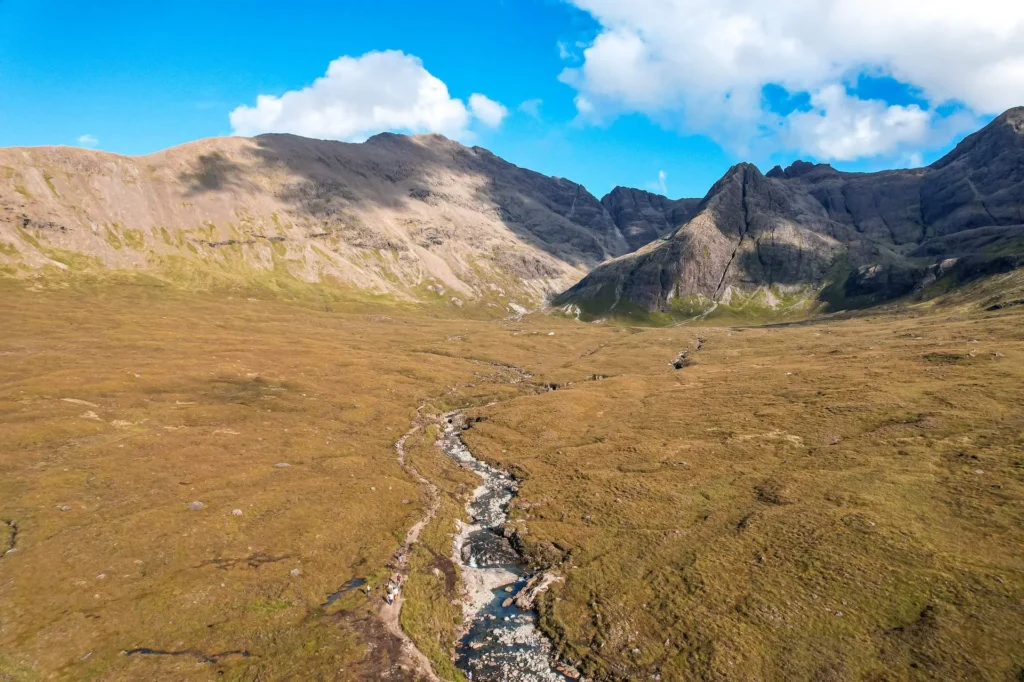 Landscape of the Fairy Pools on the Isle of Skye with a river running through a valley between mountains