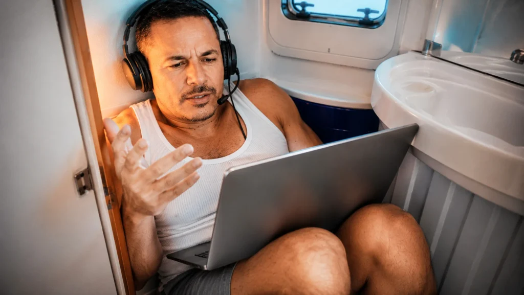 Xavier on a video call with a headset, working in vanlife from his camper van