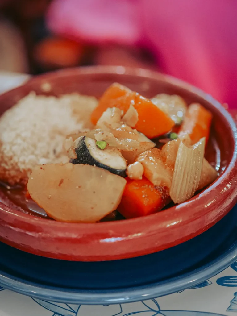 Vegetarian tajine of stewed vegetables and semolina in an earthenware dish at Nikita restaurant in Tavira, Algarve