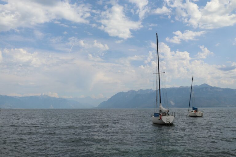 Sailing boats on Lake Geneva near Lausanne, with the Alps behind