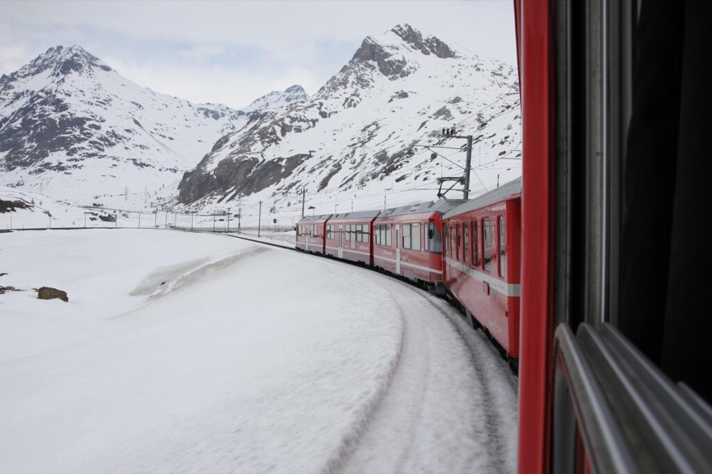 The red Bernina Express train in the snowy Swiss Alps