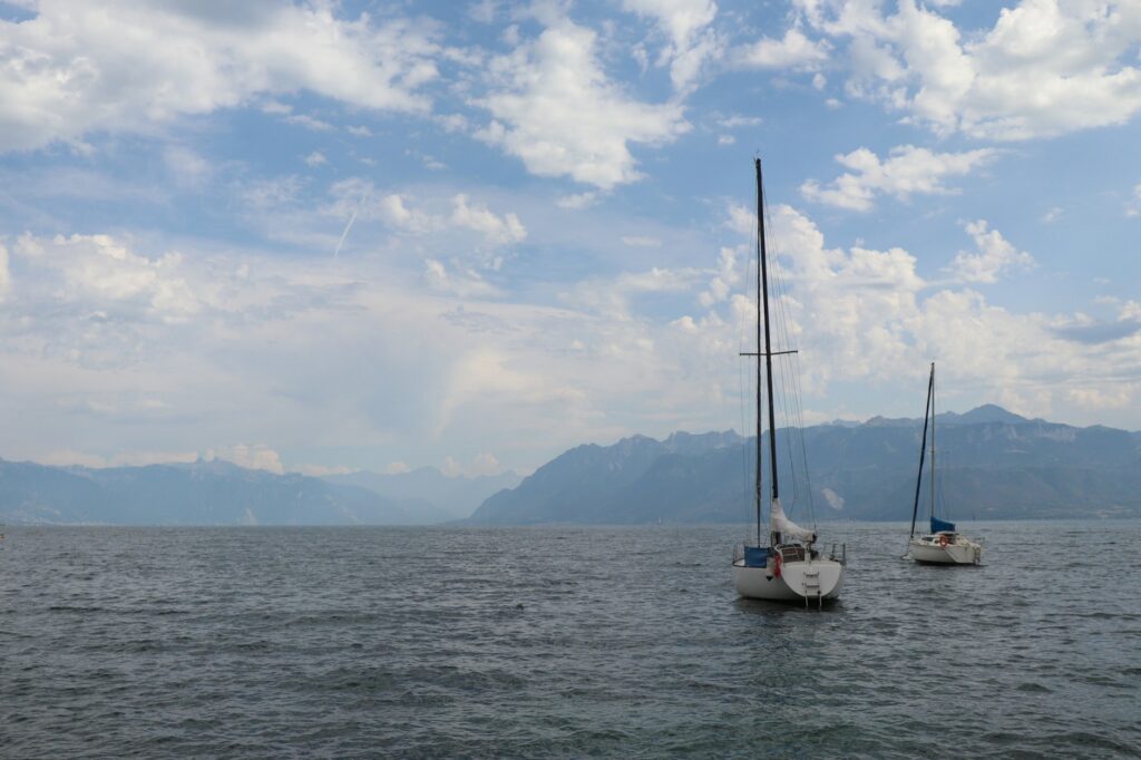 Sailboats on Lake Geneva near Lausanne, with the Alps in the background
