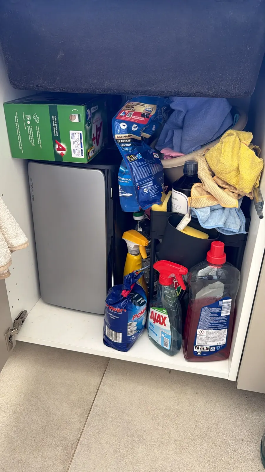 EcoFlow AC Pro battery fitted inside the under-sink cabinet, surrounded by cleaning products, with no overheating