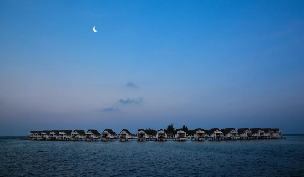 Stilt bungalows and turquoise lagoon in the Maldives seen from the sky