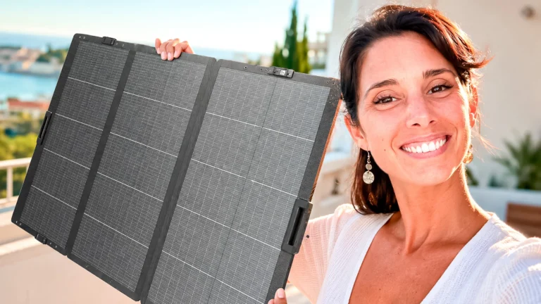 Caroline unfolds a portable solar panel in the sun on a terrace in the Algarve
