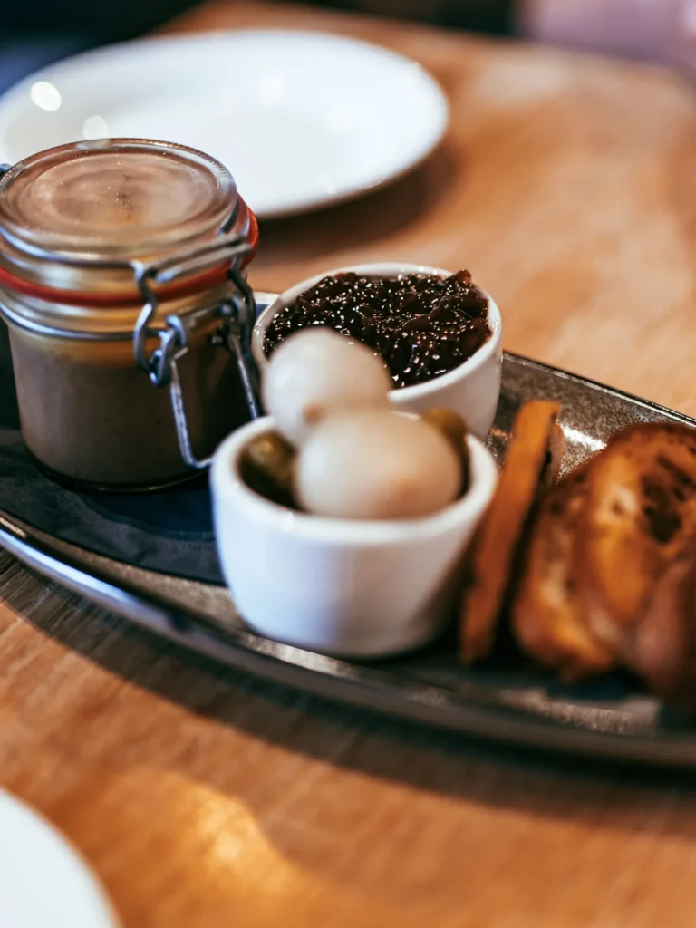 Tasting plate at the Allan Park Hotel restaurant in Stirling, consisting of jarred pâté, chutney, quail eggs, and toast, served on a wooden table in Scotland during the summer of 2026.