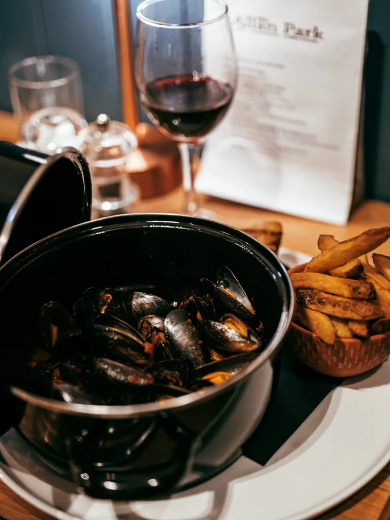 Mussels dish served with fries and a glass of red wine, on a table at the Allan Park Hotel restaurant in Stirling in August 2026.