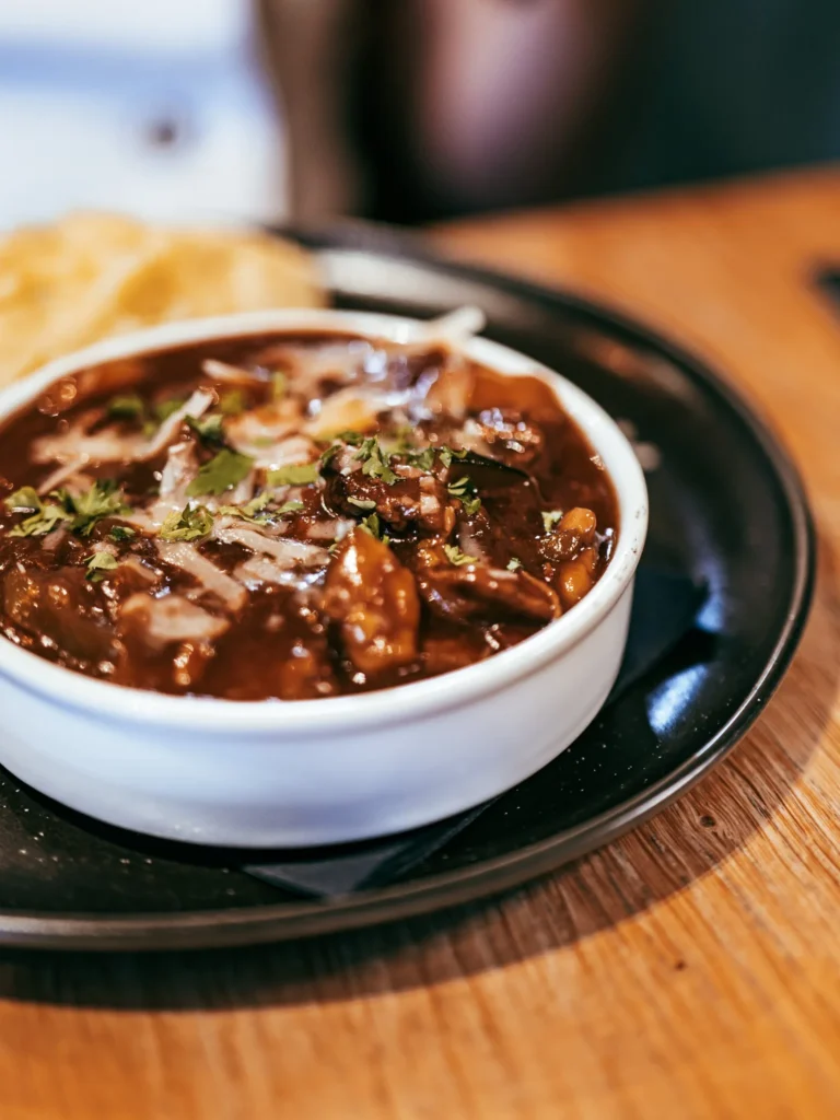 Stew served in a white bowl on a wooden table at the Allan Park Hotel restaurant in Stirling, Scotland, during the summer of 2026.