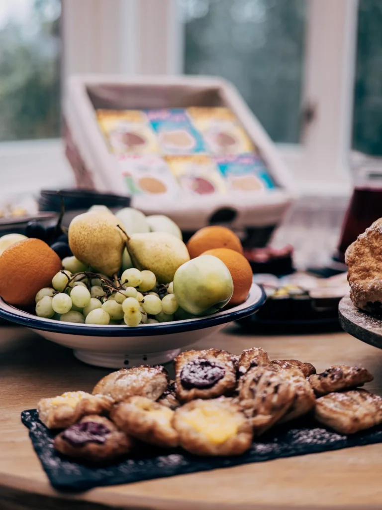 Fresh fruit platter and assortment of pastries on a table in the Allan Park Hotel room in Stirling, Scotland, in August 2026.