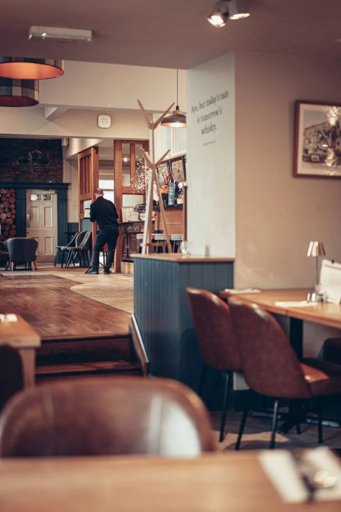 Restaurant hall of the Allan Park Hotel in Stirling, Scotland, warm atmosphere with wooden furniture and leather armchairs, taken in August 2026.