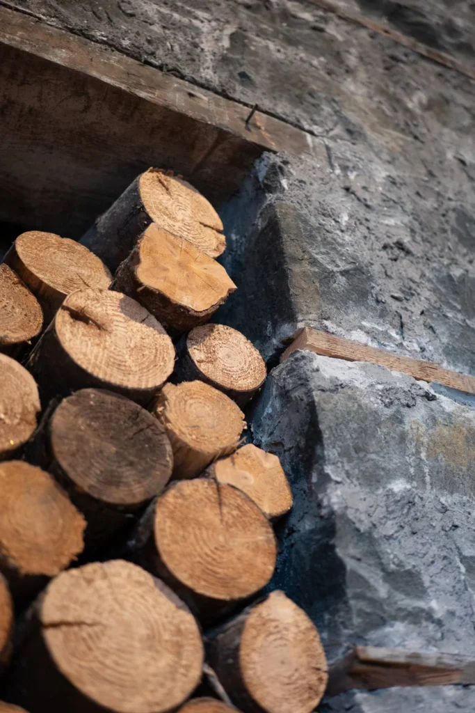 Logs are stacked against a stone wall inside the restaurant of the Allan Park Hotel in Stirling, Scotland, in August 2026.