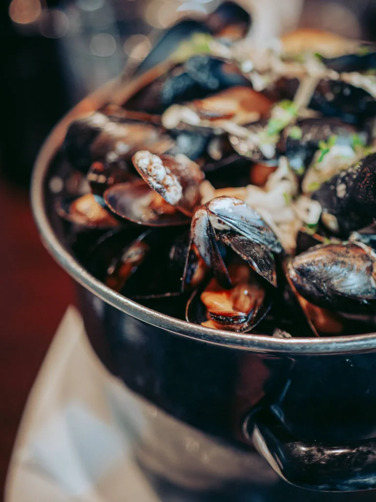 Large metal pot filled with fresh mussels from the Isle of Mull, served at the Ben Nevis Bar in Fort William.
