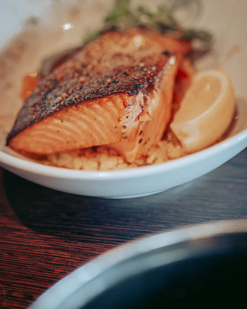 Scottish salmon fillet baked and served with a wedge of lemon at the Ben Nevis Bar in Fort William.