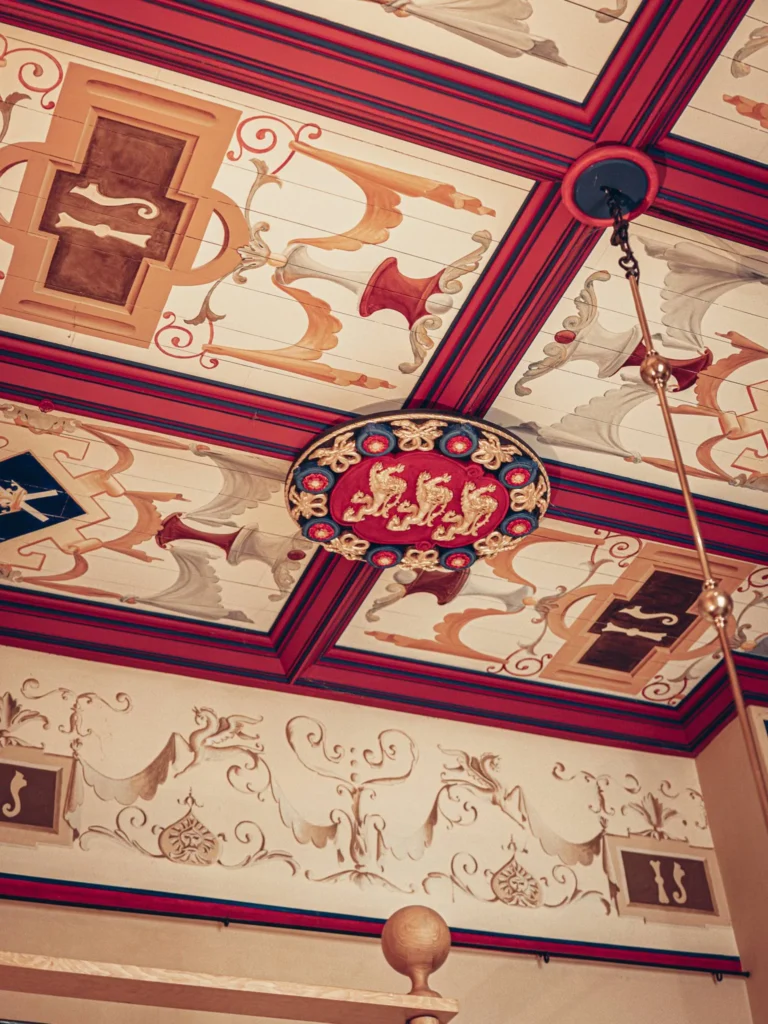 A richly decorated ceiling with painted patterns and coats of arms, typical of the restored interiors at Stirling Castle, Scotland.