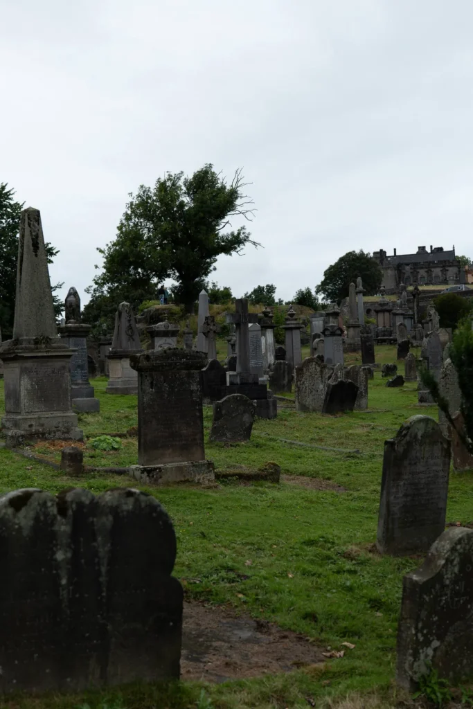 Kirkyard of the Church of the Holy Rude in Stirling: grass grows around the old headstones and sometimes over them, far from the gravel paths of French or Portuguese cemeteries.