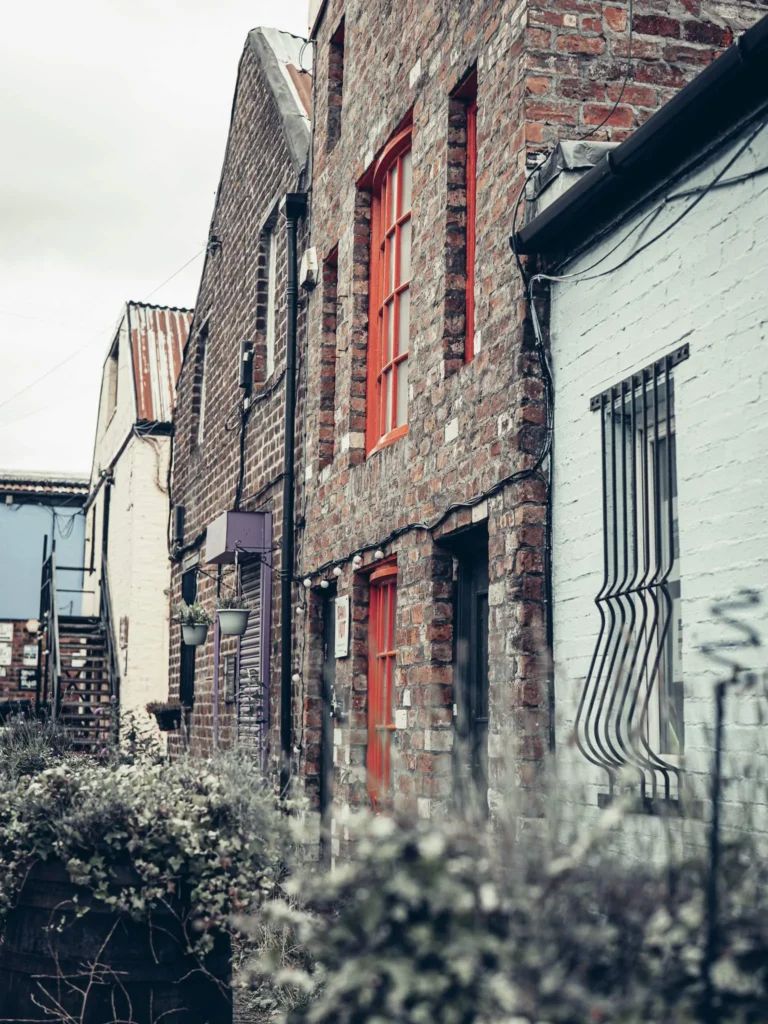 Brick facades and painted joinery in The Hidden Lane, Glasgow: even the door and window surrounds are repainted for colour, in contrast with the sandstone and stone of the rest of the city.