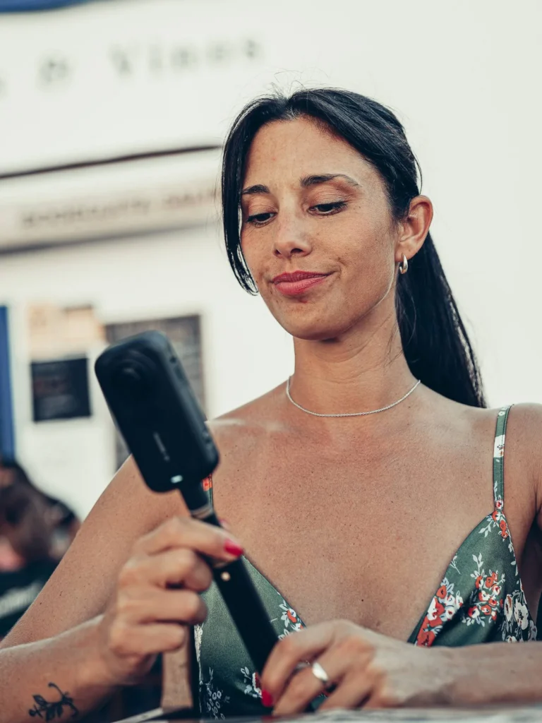 Caroline holds the Insta360 X6 outdoors during the hands-on experience