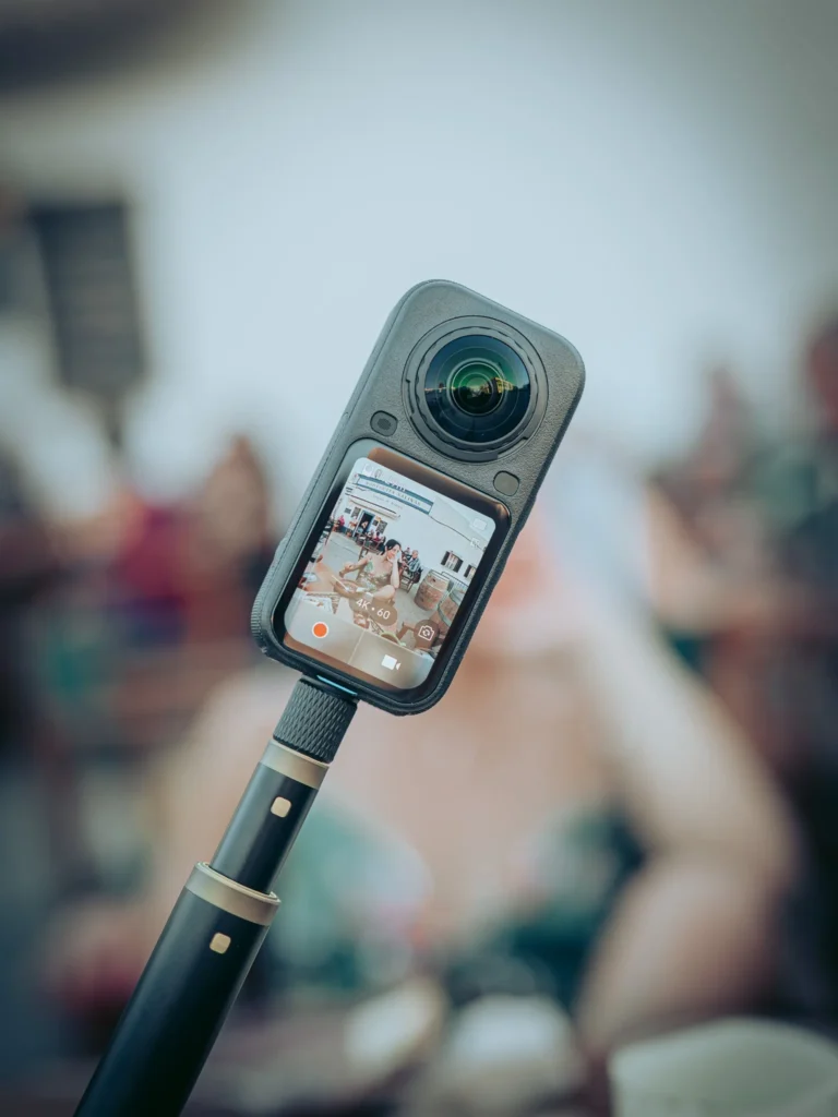 Insta360 X6 mounted on its pole, screen on displaying 4K 60 fps mode