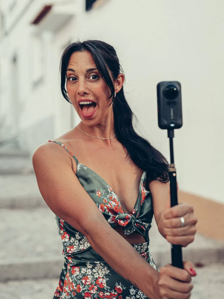 Caroline films with the Insta360 X6 mounted on a pole in front of some stairs