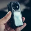 Insta360 X6 held in hand, close-up on the case and the 360 lens