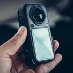 Insta360 X6 held in hand, close-up on the case and the 360 lens