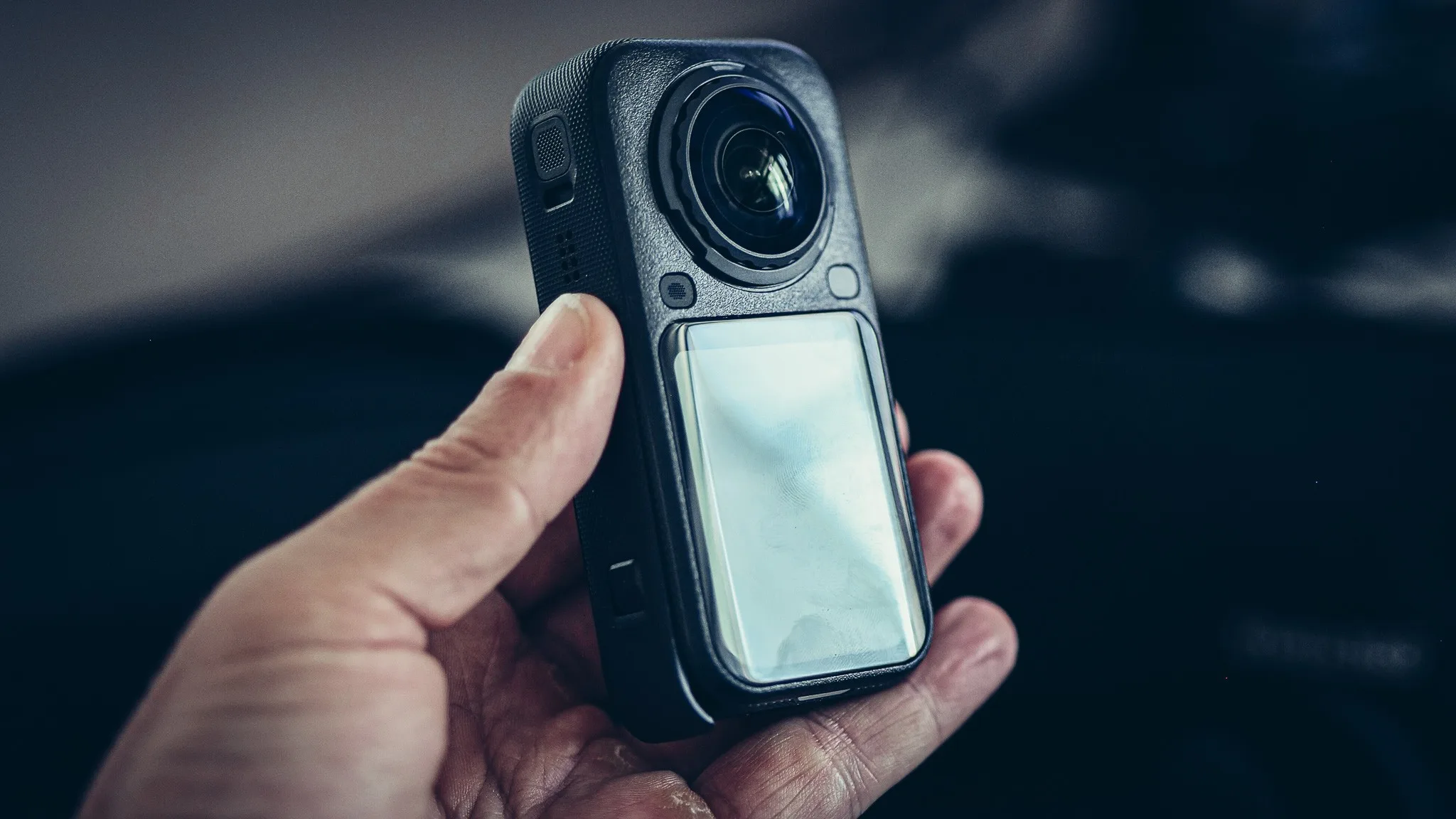 Insta360 X6 held in hand, close-up on the case and the 360 lens
