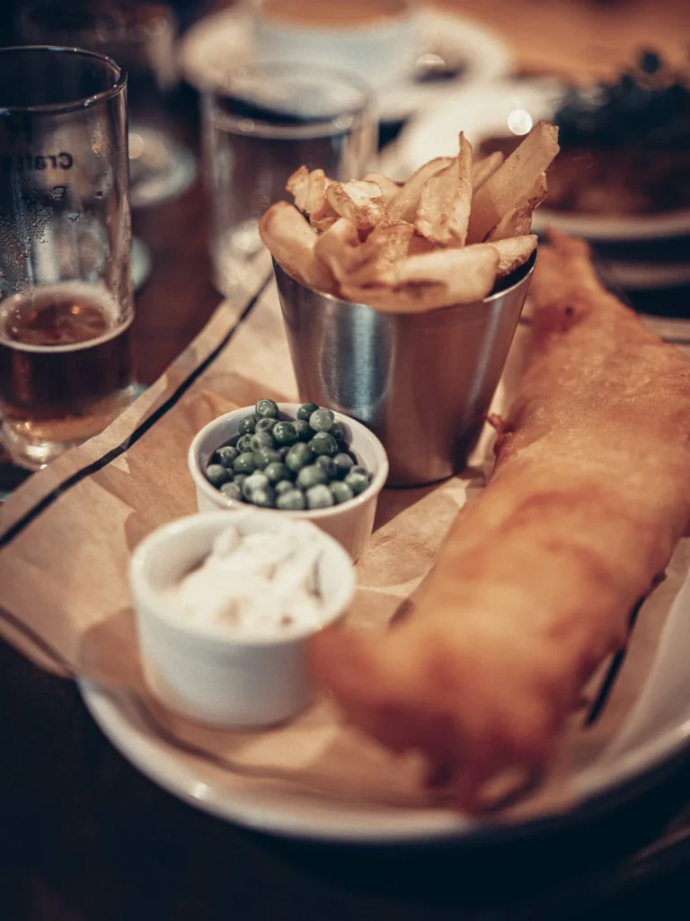 Beer Battered Haddock, Xavier's fish and chips with peas, tartare sauce and a beer, at Roam West in Inchree, Onich.
