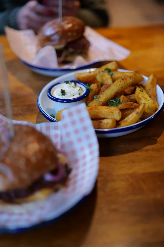 The Nae Kissin' fries with cajun seasoning, garlic butter and garlic mayo, served alongside the two burgers at Slanj-A-Va, Stirling.
