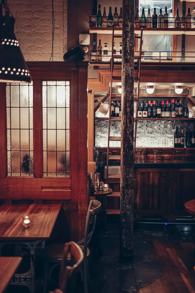 The dining room at Stravaigin, Gibson Street in Glasgow: wooden tables, heavy central pillar and metal balustrades linking the different levels of the restaurant.