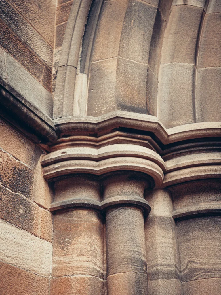 Detail of a stone column and arch from the University of Glasgow.