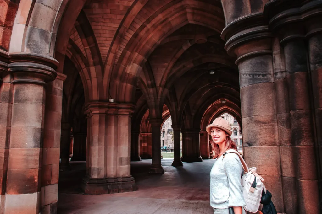 Caroline under the Gothic arches of the University of Glasgow, Scotland, on a summer day.