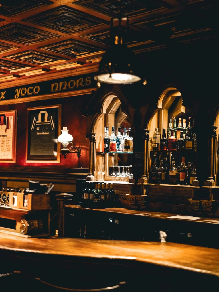 Wooden bar counter and spirits shelves at Waxy O'Connor's pub in Glasgow.