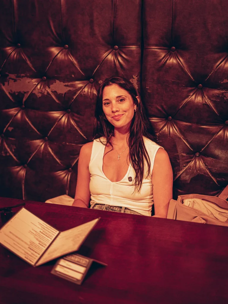 Caroline seated on a leather bench at Waxy O'Connor's pub in Glasgow