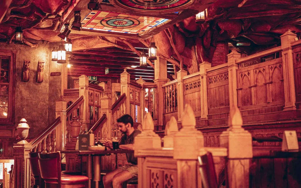 Xavier is seated in the carved wood decor of the Waxy O'Connor's pub in Glasgow.