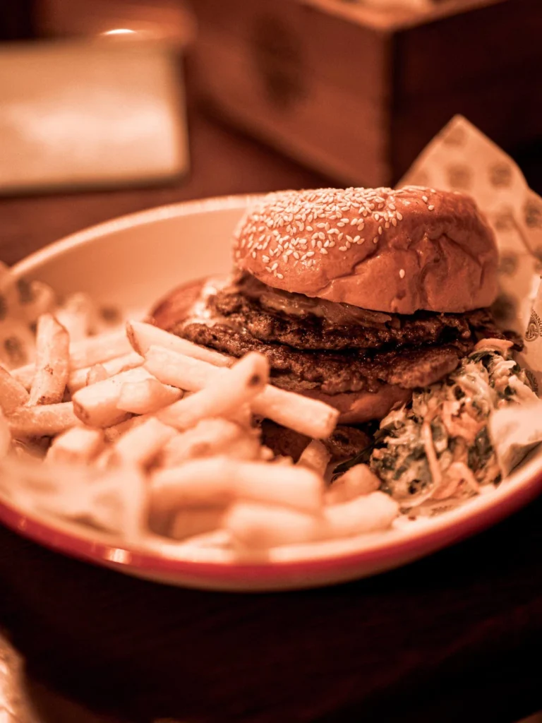 Burger plate with chips and coleslaw at Waxy O'Connor's pub in Glasgow.