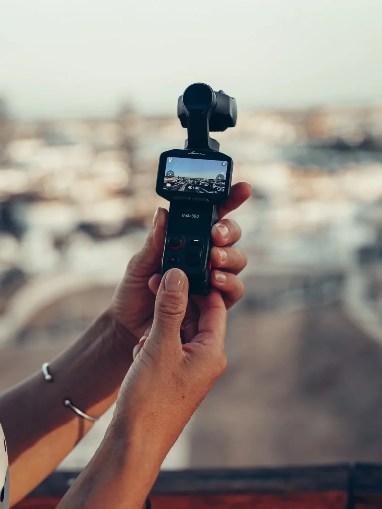 Caroline holds the Insta360 Luna Pro outdoors, video preview on the screen