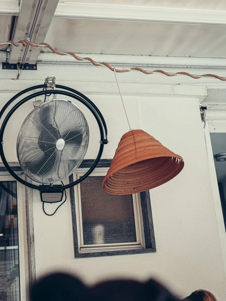 Wall fan and wicker ceiling suspension in a restaurant in Tavira, Algarve, Portugal, in September 2026.
