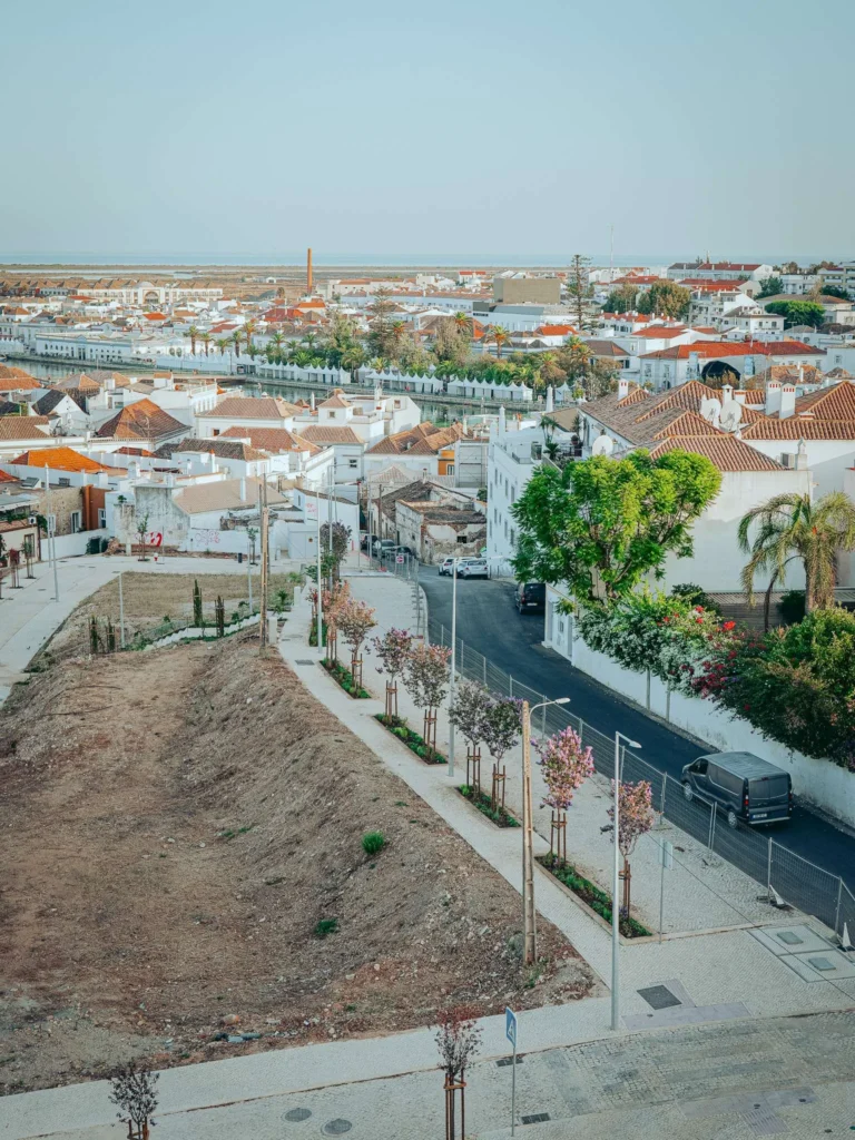 Bird's-eye view of the rooftops and streets of Tavira from the Nomad, with the Rio Gilao visible in the background.