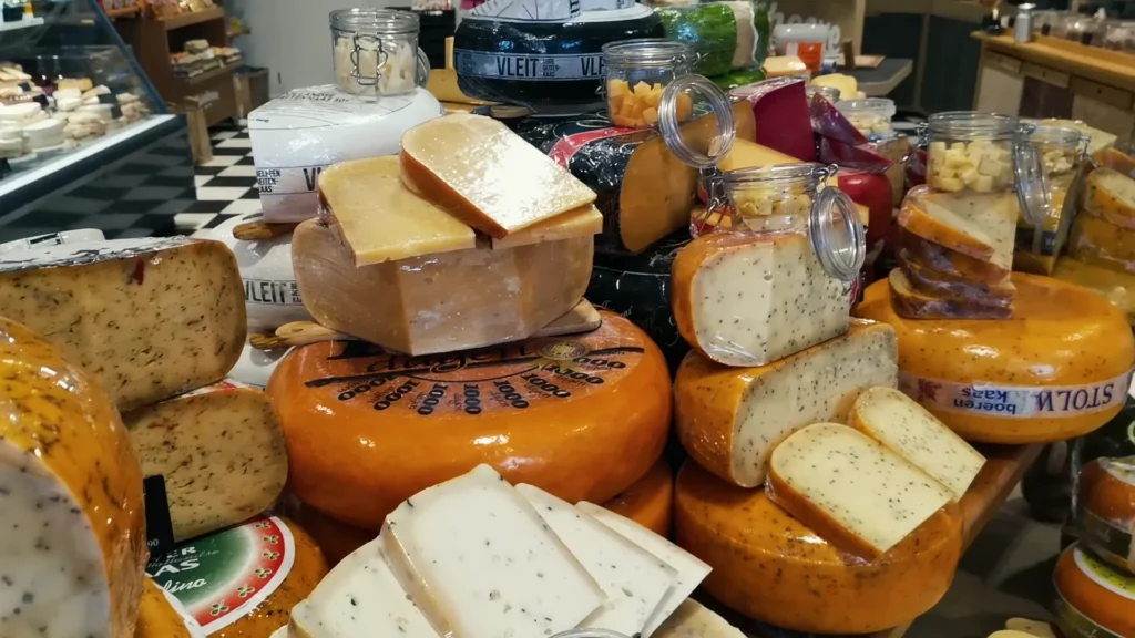 Cheese wheels and wedges in an Alkmaar shop