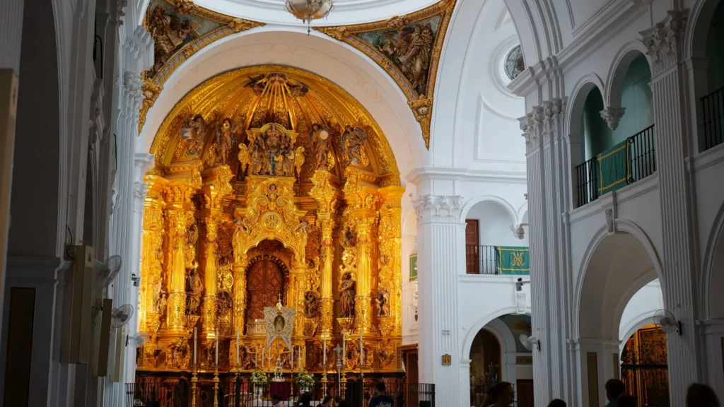 White nave and gilded altarpiece inside El Rocío sanctuary on 17 October 2026
