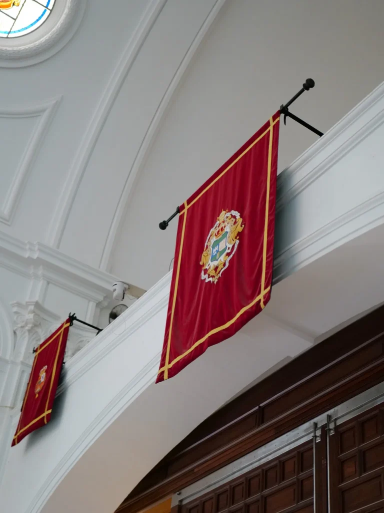 Red hanging bearing the arms of Almonte’s Hermandad Matriz in El Rocío sanctuary